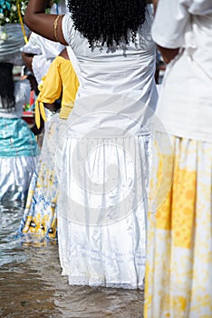 Candomble people are seen entering the sea water to honor iemanja during a party on Rio Vermelho beach. Salvador, Bahia