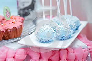 Candy bar with blue cake pops and pink muffins. Festive sweets for girl birthday