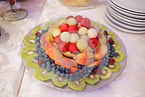 Candy bar.Different delicious fruits on wedding reception table with bananas and grapes