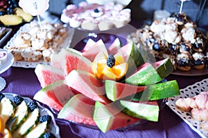 Candy bar.Different delicious fruits on wedding reception table with bananas and grapes