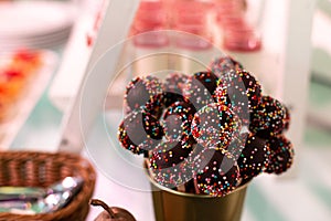 Candy bar. Sweets on a stick with sprinkles. Selective focus