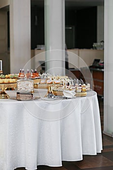 Candy bar. Table with sweets, candies, and dessert. Wedding event