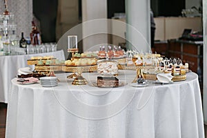 Candy bar. Table with sweets, candies, and dessert. Wedding event