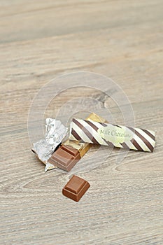 A candy bar unwrapped and broken