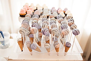 Sweet candy bar.Different delicious cake on wedding reception table with bananas and grapes photo