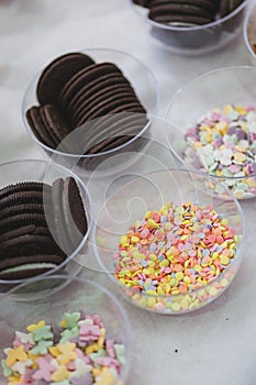 Candy and biscuits party mix, sweets in bowls, children market