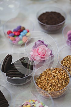 Candy and biscuits party mix, sweets in bowls, children market