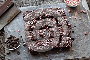 Candy Cane Chocolate Brownies Cut in Squares on Rustic Wood Background