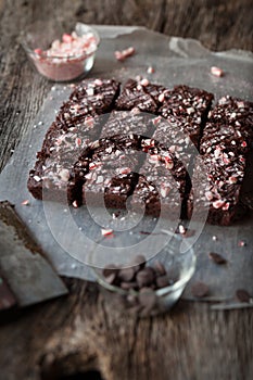 Candy Cane Chocolate Brownies Cut in Squares on Rustic Wood Background