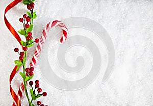 Candy Cane With Christmas Decoration On Snowy Background