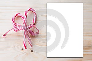 Candy Cane frame with blank empty paper white mockup for blog design on wooden background top view mock up