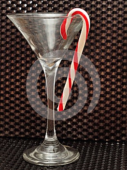 Candy cane hanging in a martini glass