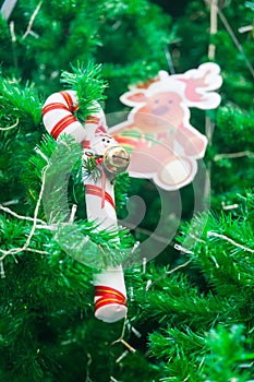 Candy cane with mini santa and reindeer ornament on Christmas Tree