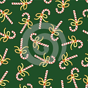 Candy Cane seamless Christmas vector pattern. Repeating background with hand drawn candy canes with shiny gold foil bows on green.