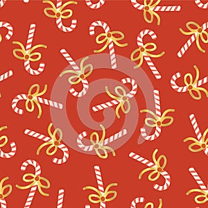 Candy Cane seamless vector pattern. Christmas repeating background with hand drawn candy canes with shiny gold foil bows on red.