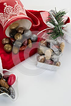 Candy canes, candies and chocolate on Santa hat isolated