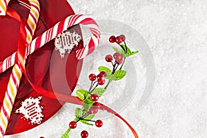 Candy Canes On Red Plate With Christmas Decoration Around