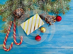 Candy, Christmas branch, vintage frame decoration border present snow gift box on a blue wooden background present