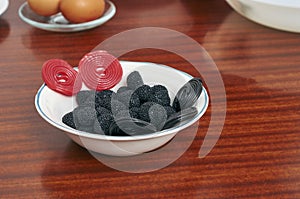 Candy in a dish and eggs in the background to make a cake