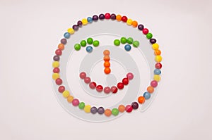 Candy emoticon on white background