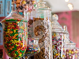 Candy jars filled with candy, glass, caramels, fruit, balls