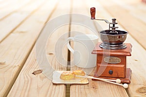 Candy lollipop and coffee mill on wooden background