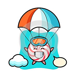 Candy mascot cartoon is skydiving with happy gesture