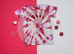 Candy, paint and tie dye T-shirt in red and white. Flat lay
