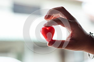 Candy red heart in hand a boy.