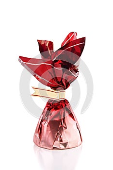 Candy in red wrapper isolated on white