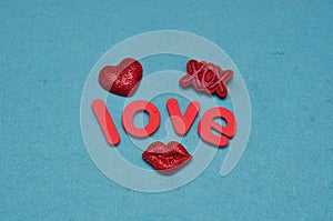 A candy shape lips , red heart and XOX with the word love