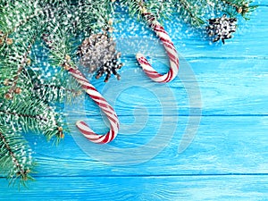 Candy, snow bump frame seasonal greeting design on a wooden background, Christmas tree