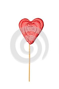 Candy on a stick in the form of a bright red heart isolated on a white background