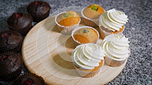 Candy store. The woman prepares for a holiday. The confectioner cooks cupcakes. Cakes are ready on a table. on a table