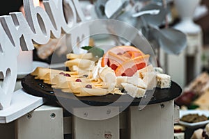 Candybar in a restaurant. Decorated white table fool of sweet pastry