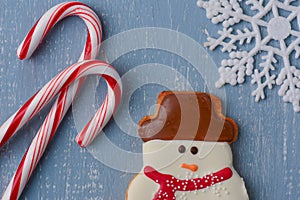 Candycanes, Snowman Cookie and Snowflake on Light Blue Wood Back