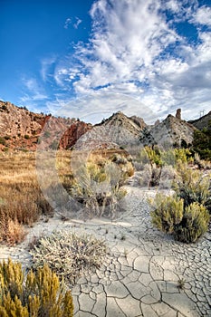 Candyland cracked earth and colorful sandstone rock formations