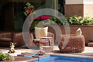 Cane chairs beside pool