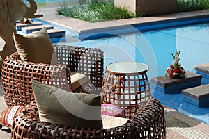 Cane chairs beside pool
