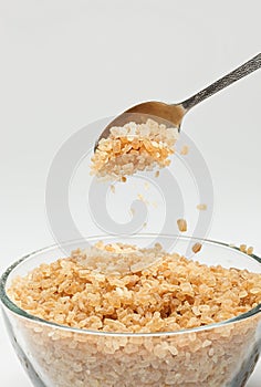Cane sugar falling from a tea-spoon