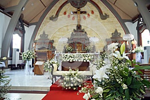 Canggu, Bali Indonesia - September 28, 2023: Balinese Catholic church interior with wedding flowers decoration in white.