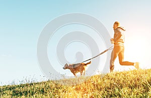 Canicross exercises. Man runs with his beagle dog at sunny morning photo