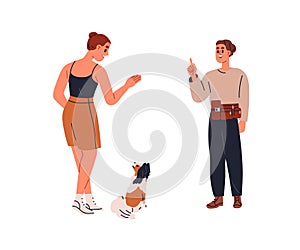 Canine trainer teaching dog owner to give command, gesturing to puppy. Professional doggy specialist training puppy