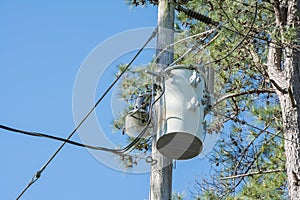 A Canister Inductor Mounted On A Power Pole.