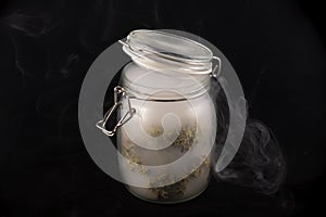 Cannabis buds maui skunk strain on a glass jar with smoke isol