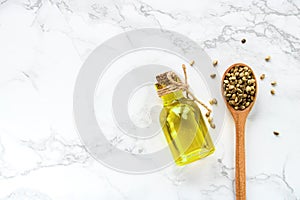 Cannabis oil and hemp seeds on a white background.