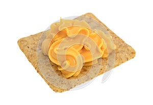 Canned cheese on an organic whole grain wheat cracker