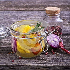 Canned colorful different vegetables Assorted glass jar with spices, oil, vinegar, salt and sugar in a simple dark