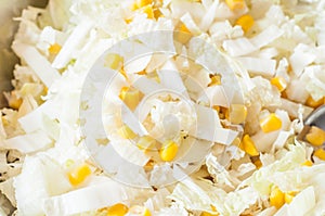 Canned corn mixed with onions and white cabbage for salad