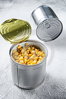 Canned corn in a tin can. canned food. White background. Top view